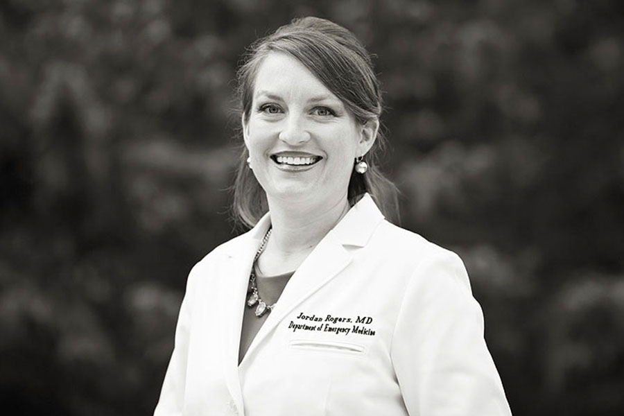 Biological science alumna Jordan Rogers in her white coat. 