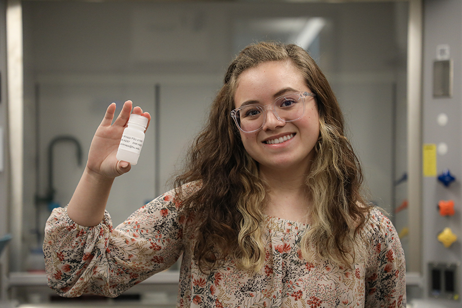 Andrea Emmanuelli with one of the water samples taken during her three-week research cruise in Alaska. Photo courtesy Andrea Emmanuelli.