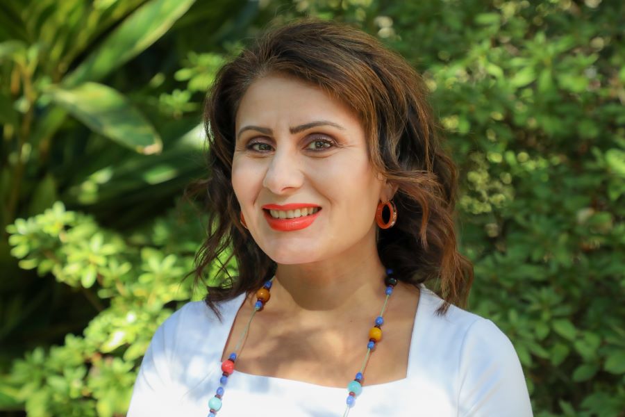 This is a headshot of Nilay Özok-Gündoğan in front of some greenery. 