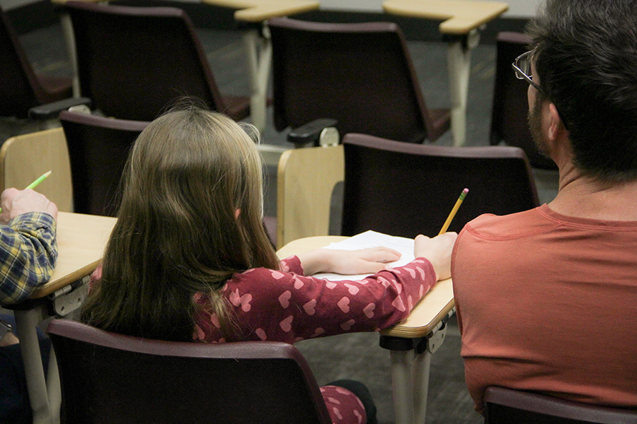 An attendee solves a puzzle in a traditional FSU classroom setting. (Carly Nelson/College of Arts and Sciences)