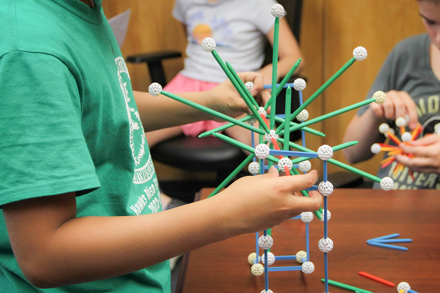 Visitors played with geometric construction tools. (Carly Nelson/College of Arts and Sciences)