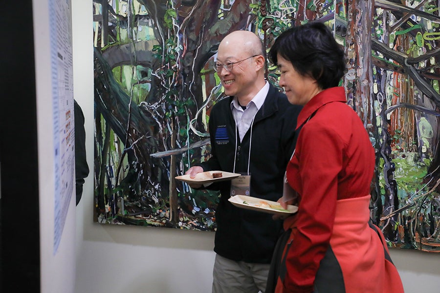 Conference participants attend the poster reception.