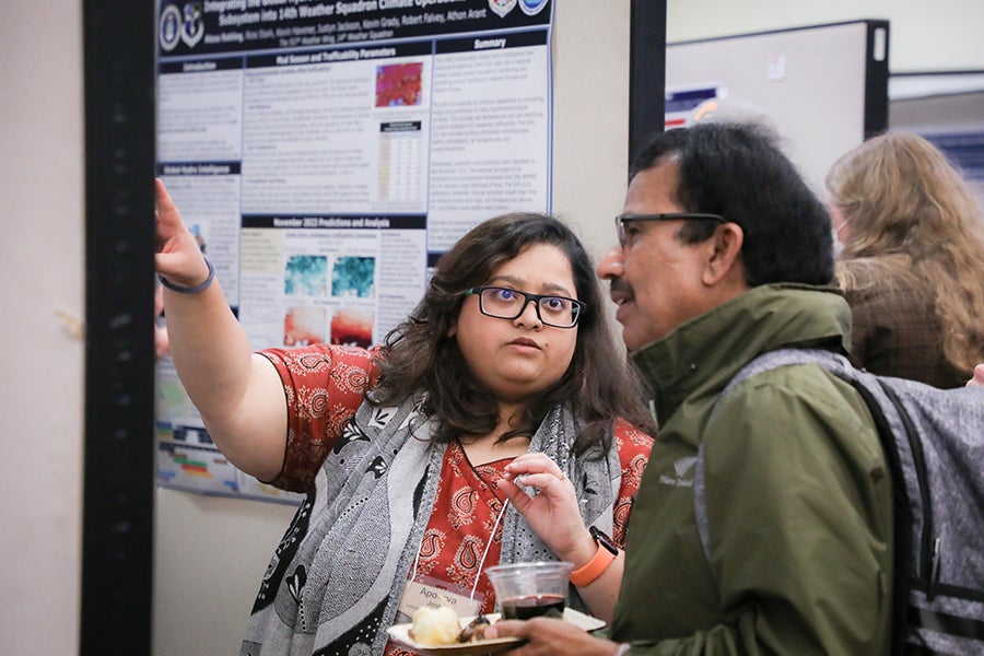 Conference participants attend the poster reception.