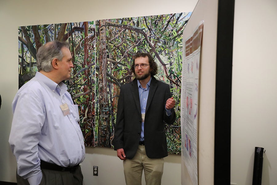 Conference participants attend the poster reception.