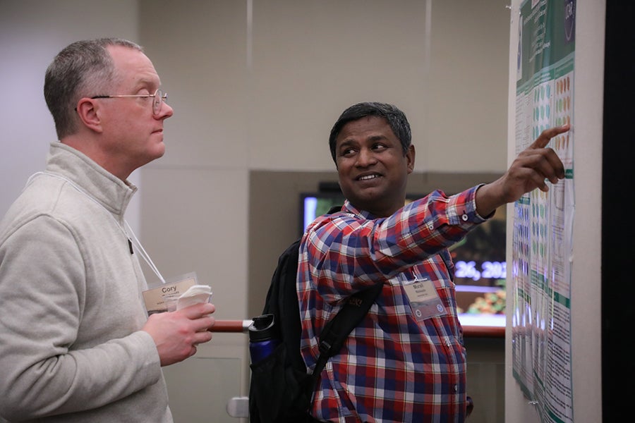 Conference participants attend the poster reception.