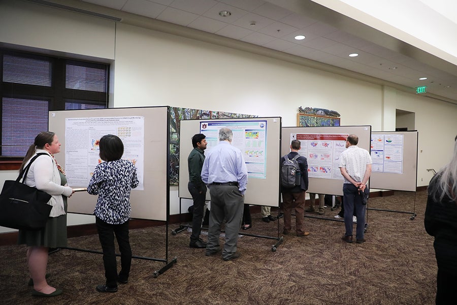 Conference participants attend the poster reception.