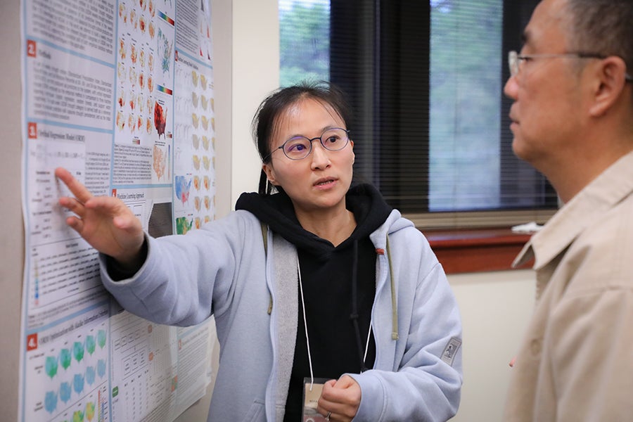 Conference participants attend the poster reception.
