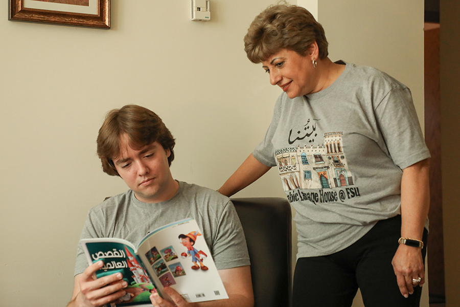 Zeina Schlenoff and an FSU Arabic Language House resident read a book in Arabic. Photo by Devin Bittner.