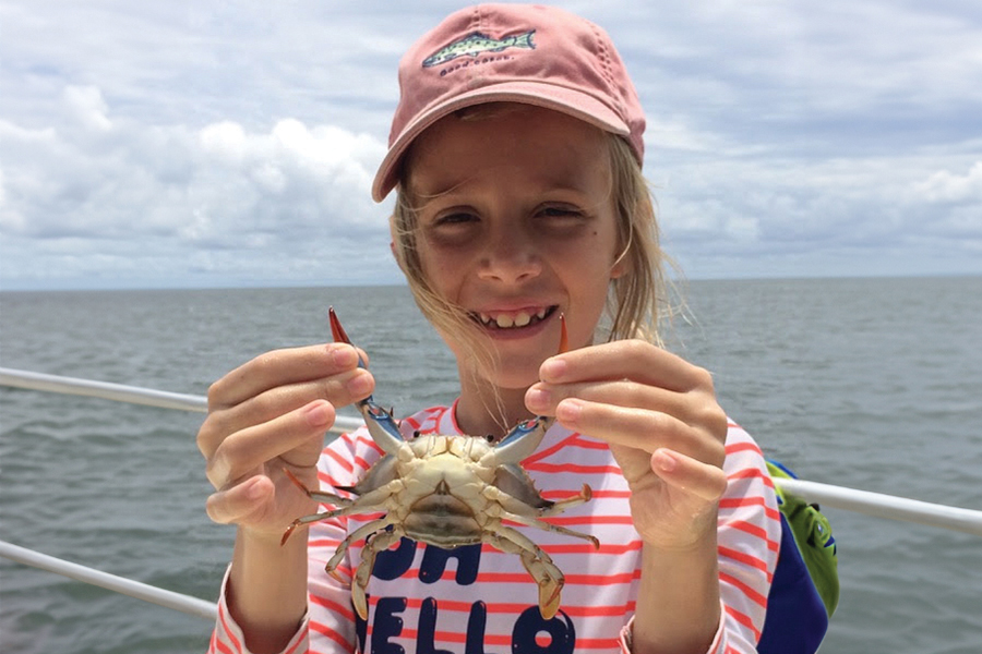 An attendee at Saturday-at-the-Sea experiences marine life up close. Courtesy photo.