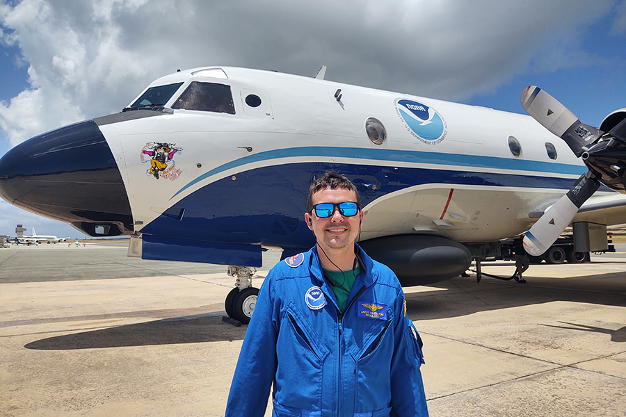 Andrew Hazelton standing outside a NOAA Aircraft Operations Center plane. Courtesy Andrew Hazelton.