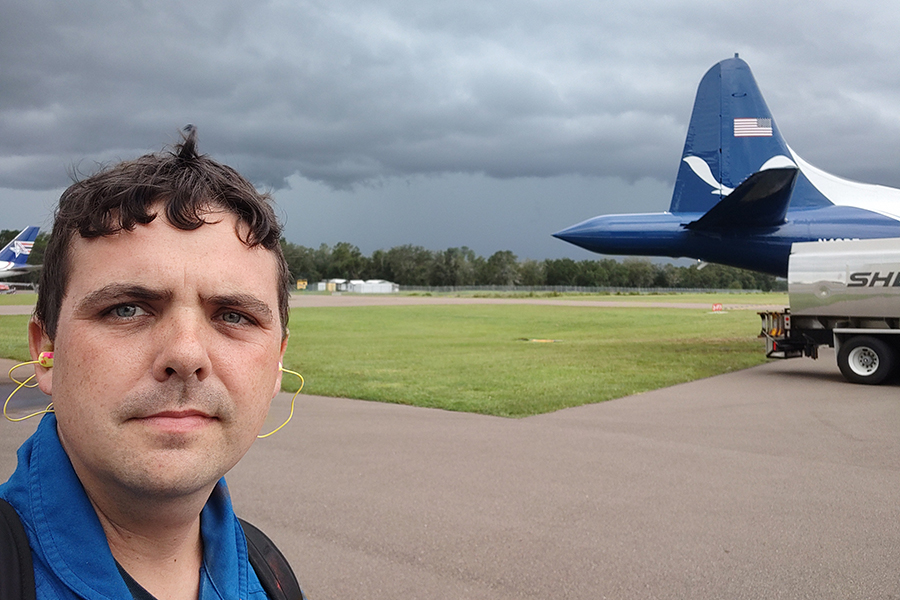 Andrew Hazelton standing outside a NOAA Aircraft Operations Center plane before an expedition into Hurricane Helene in 2024. Courtesy Andrew Hazelton.