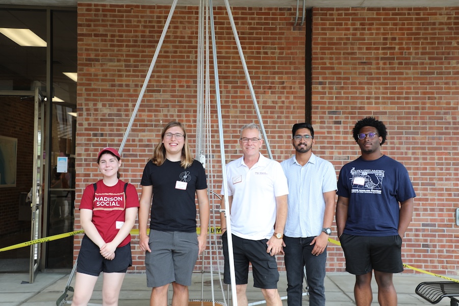 Charles Carpenter (middle) is the director of Science-on-the-Move program, which brings the resources needed to conduct high-tech physical science lessons directly to regional K-12 classrooms, and co-director of the Young Scholars Program, a six-week residential summer program for 40 of Florida’s highest-performing high school students with significant potential for careers in the fields of science, technology, engineering and mathematics. Photo by Kendall Cooper.