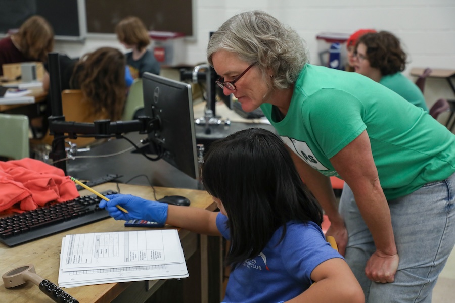 Julie Sear, a science teacher at the School of Arts and Sciences on Thomasville Road, assists students during the Nuclear Medicine and Science Camp. Photo by Carly Nelson.