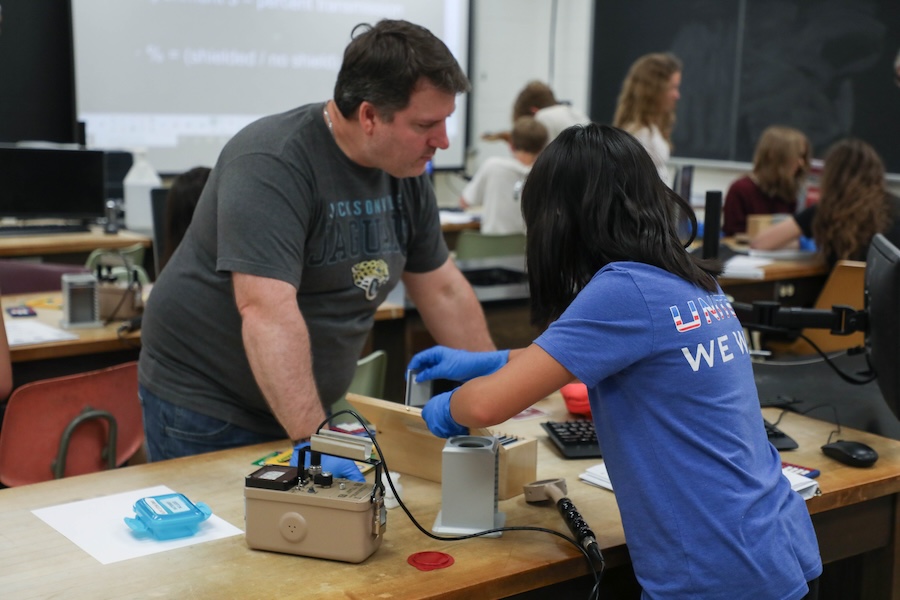 Jason Clark, a physics and computer science teacher at Chiles High School, assists students with Geiger counters during the Nuclear Medicine and Science Camp. Photo by Carly Nelson.