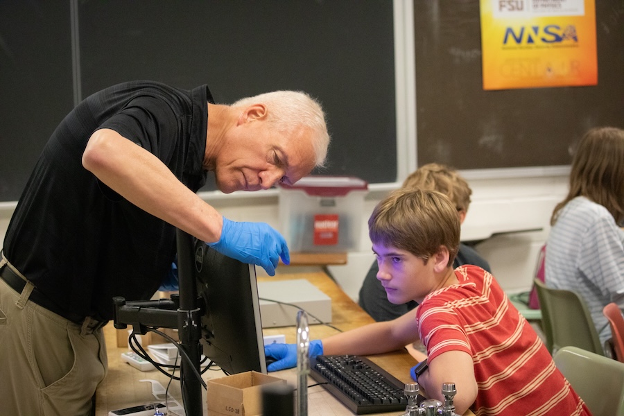 FSU physics professor and associate chair Paul Cottle assists a student during the Nuclear Medicine and Science Camp. Photo by Devin Bittner.