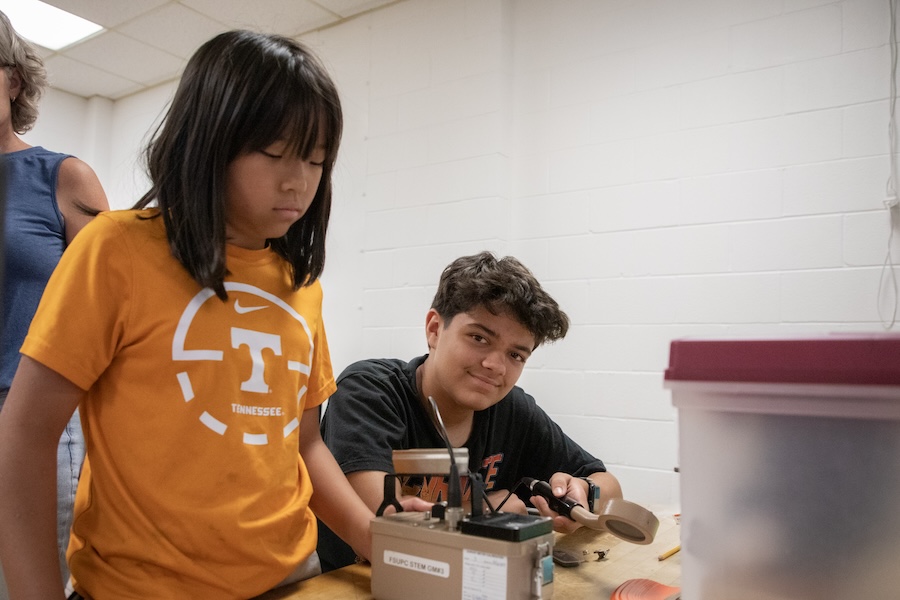 Middle school students use Geiger counters, a device for measuring the presence and frequency of radiation, to study how gamma rays are adsorbed in a variety of materials. Photo by Devin Bittner.
