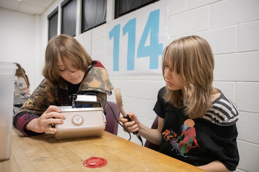 Middle school students use Geiger counters, a device for measuring the presence and frequency of radiation, to study how gamma rays are adsorbed in a variety of materials. Photo by Devin Bittner.