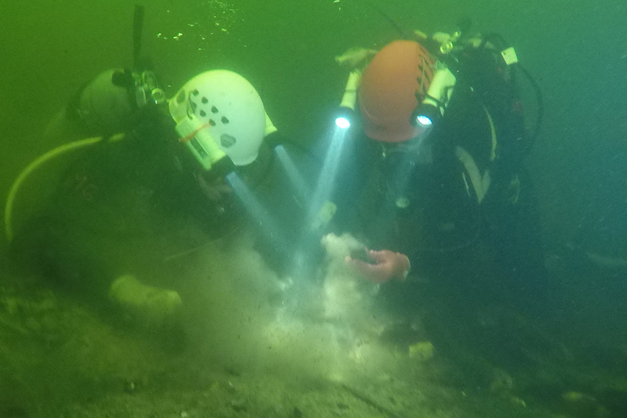  Former assistant professor of anthropology Jessi Halligan and a visiting researcher explore an archaeological site in the Aucilla River. Photo by Chris Peters.