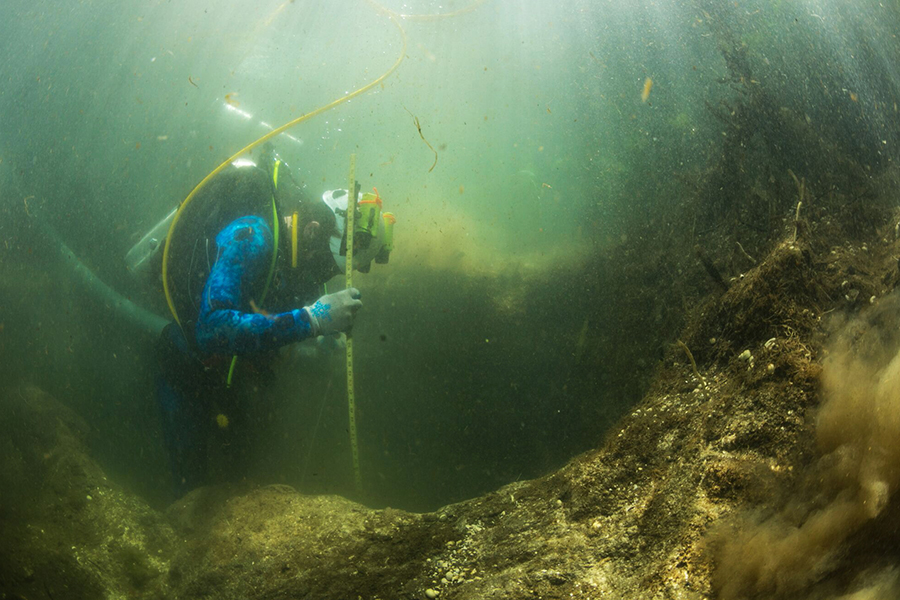 Underwater archaeology master's alumnus Shawn Joy measures the depth of an excavation at an archaeological dive in Florida. Courtesy photo.