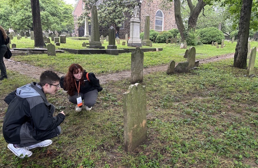 Evans and MacKinlay examine a historic gravestone at the Old Swedes Church, built in 1698, in Wilmington, Delaware. This church is one of the US’s oldest church buildings that is still in regular use as a church. Photo by Conti.