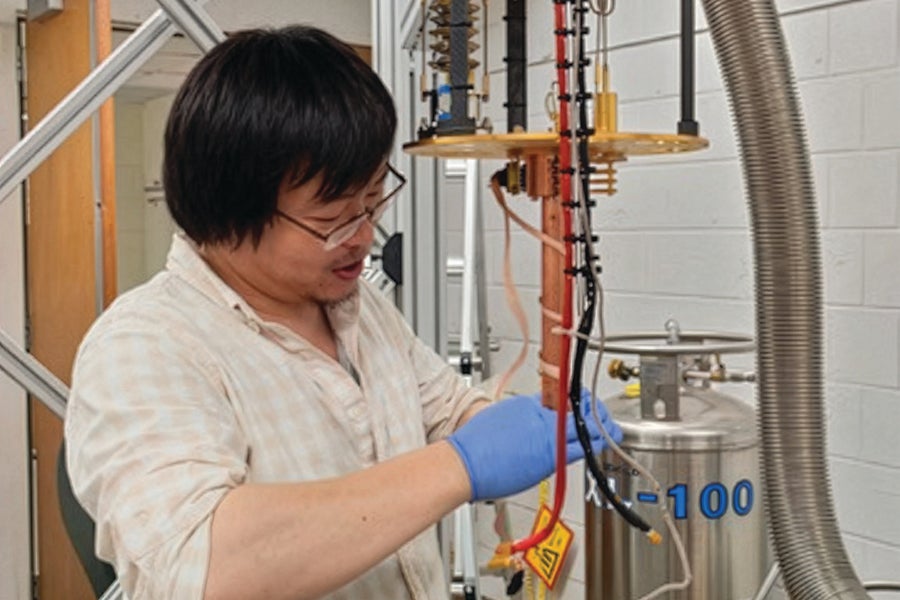 Zhengguang Lu sets up an experiment at the National High Magnetic Field Laboratory. 