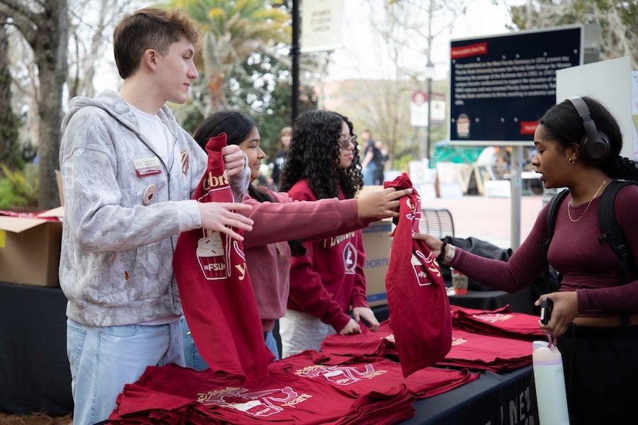 Orientation leaders hand out commemorative T-shirts at FSU's 175th Anniversary Celebration. Photo by Devin Bittner.