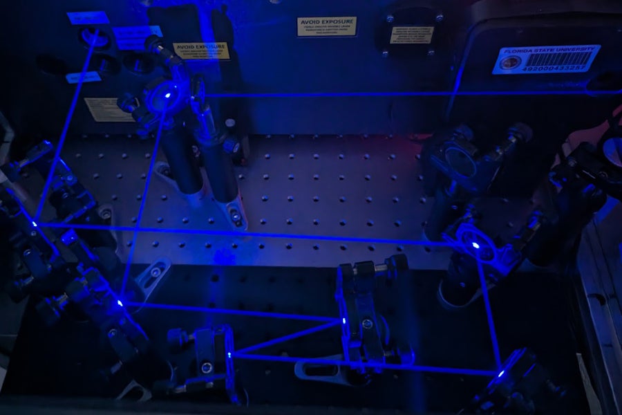 The lasers used by researchers in the study. The image shows the blue/UV light used to excite the sample in their ultrafast experiments. (Courtesy of Rachel Weiss)