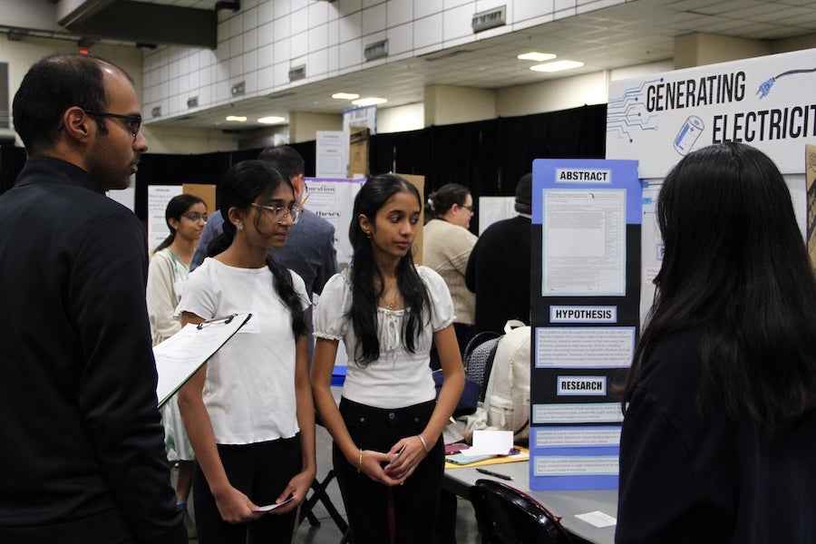 A group of students discuss their poster with judges at the 2026 Capital Regional Science and Engineering Fair Feb. 13 in Tallahassee, Florida. Photo by Bella Bozied.