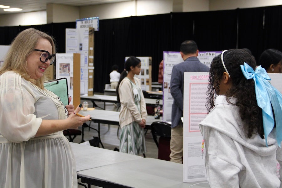 A student discusses their poster with a judge at the 2026 Capital Regional Science and Engineering Fair Feb. 13 in Tallahassee, Florida. Photo by Bella Bozied.