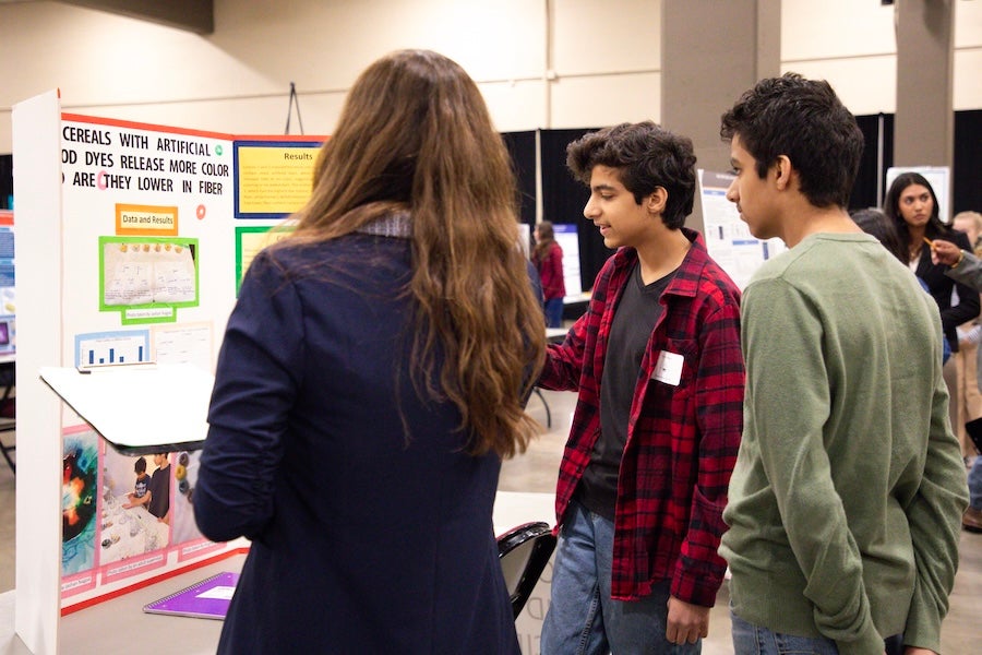 A student presents their poster to a group of judges at the 2026 Capital Regional Science and Engineering Fair Feb. 13 in Tallahassee, Florida. Photo by Éabha Phelan.