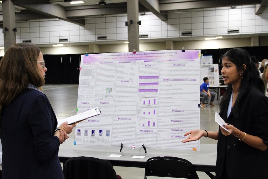 A student discusses their poster with a judge at the 2026 Capital Regional Science and Engineering Fair Feb. 13 in Tallahassee, Florida. Photo by Bella Bozied.