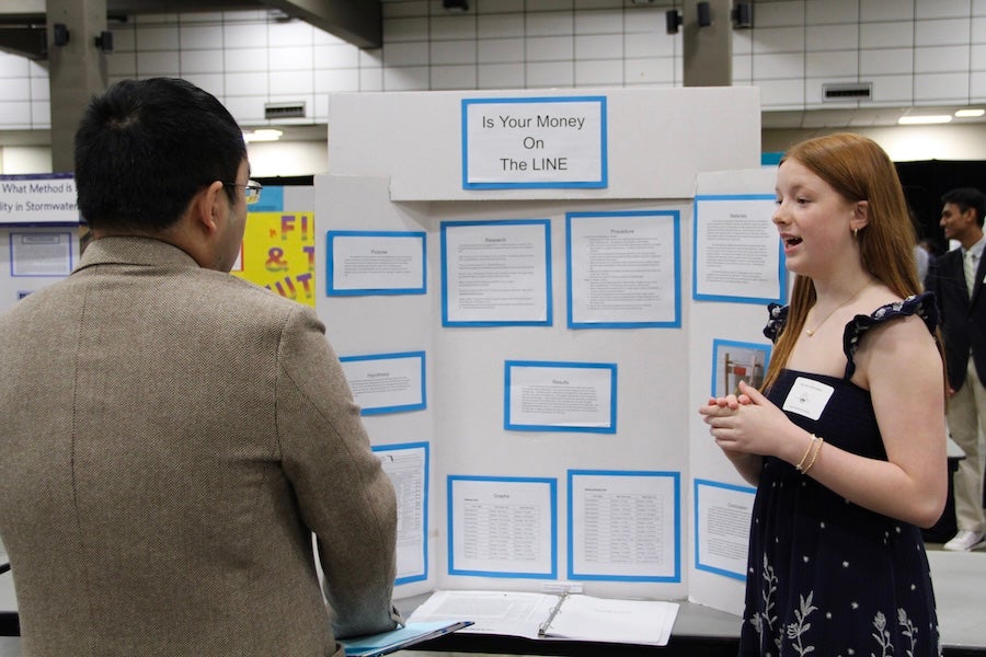 A student discusses their poster with a judge at the 2026 Capital Regional Science and Engineering Fair Feb. 13 in Tallahassee, Florida. Photo by Bella Bozied.