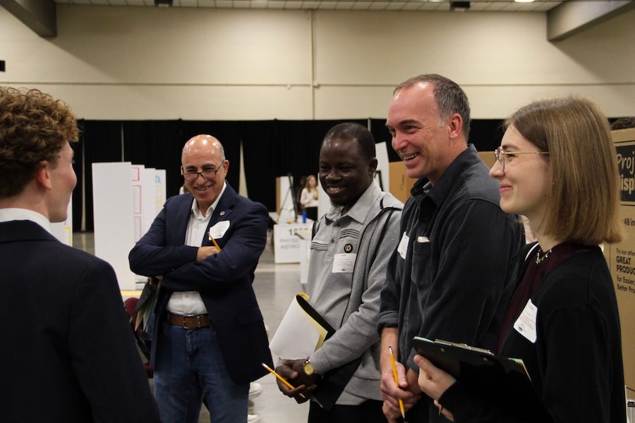A student discusses their poster with a group of judges at the 2026 Capital Regional Science and Engineering Fair Feb. 13 in Tallahassee, Florida. Photo by Bella Bozied.