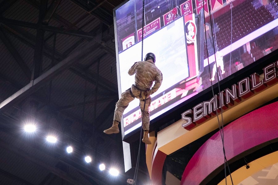 FSU Army ROTC cadets descend from the rafters as part of a rappelling demonstration at the FSU Women's Basketball game on Feb. 19, 2026 at the Donald L. Tucker Civic Center in Tallahassee, Florida. Photo by Éabha Phelan.