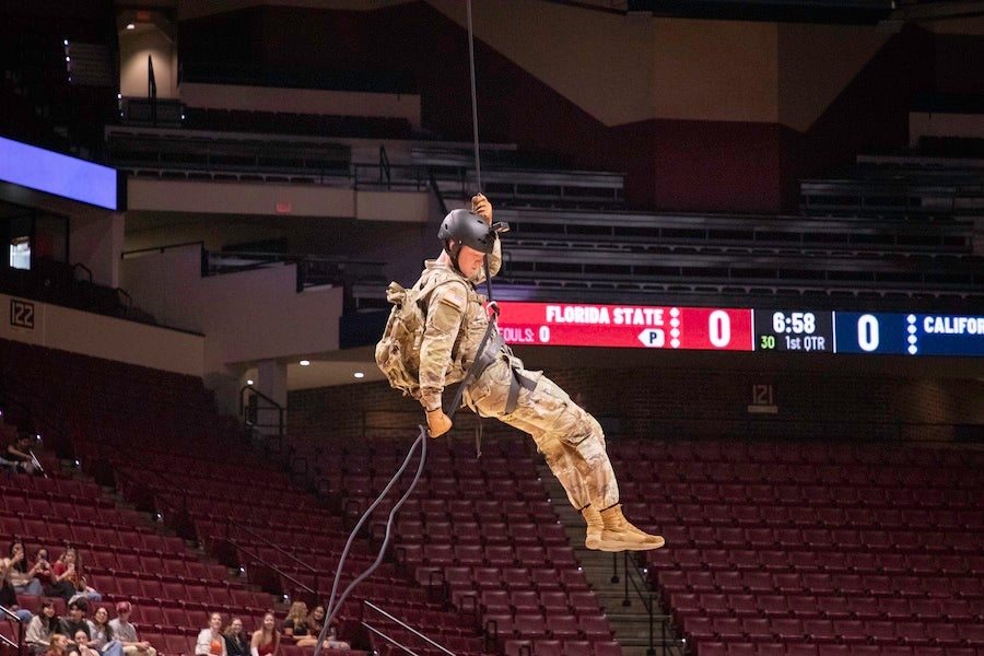 FSU Army ROTC cadets descend from the rafters as part of a rappelling demonstration at the FSU Women's Basketball game on Feb. 19, 2026 at the Donald L. Tucker Civic Center in Tallahassee, Florida. Photo by Éabha Phelan.