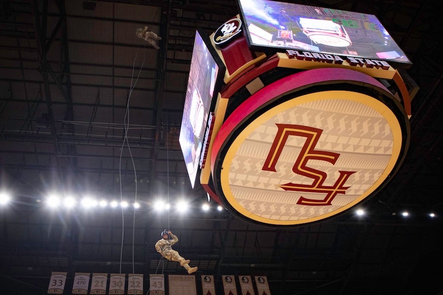 FSU Army ROTC cadets descend from the rafters as part of a rappelling demonstration at the FSU Men's Basketball game on Feb. 17, 2026 at the Donald L. Tucker Civic Center in Tallahassee, Florida. Photo by Jack LaBruno.
