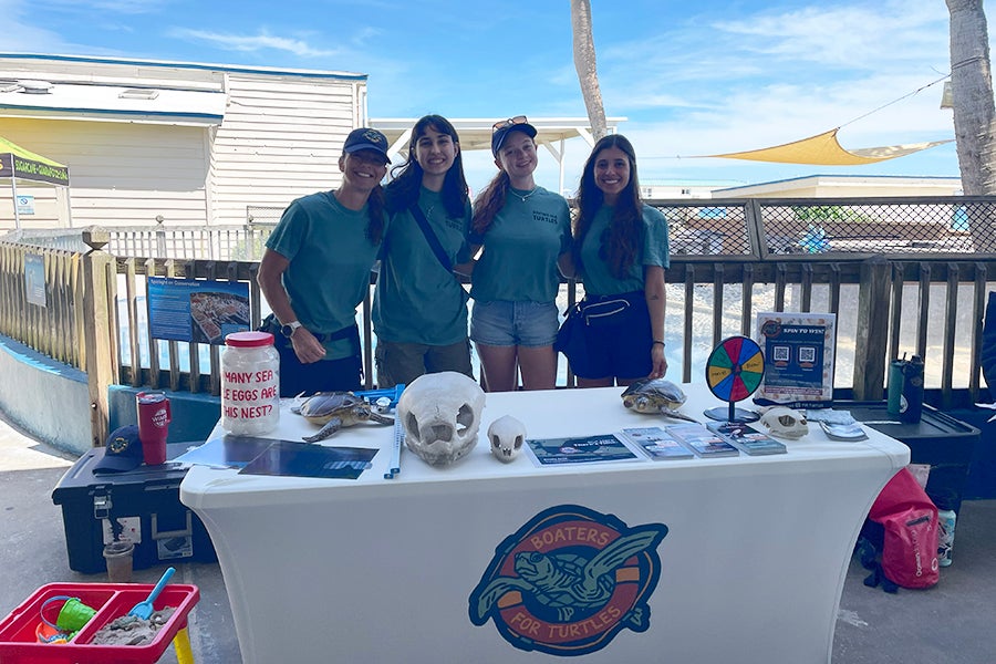 Florida State University Professor Mariana Fuentes and students share information about the Boaters for Turtles campaign at the CARE on the Coast Turtle Fest in Destin