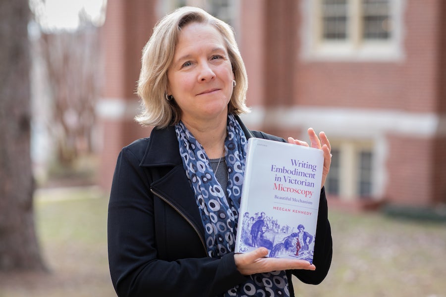 Headshot of Meegan Kennedy, outside the FSU Williams Building, holding her latest book. Photo by Devin Bittner.