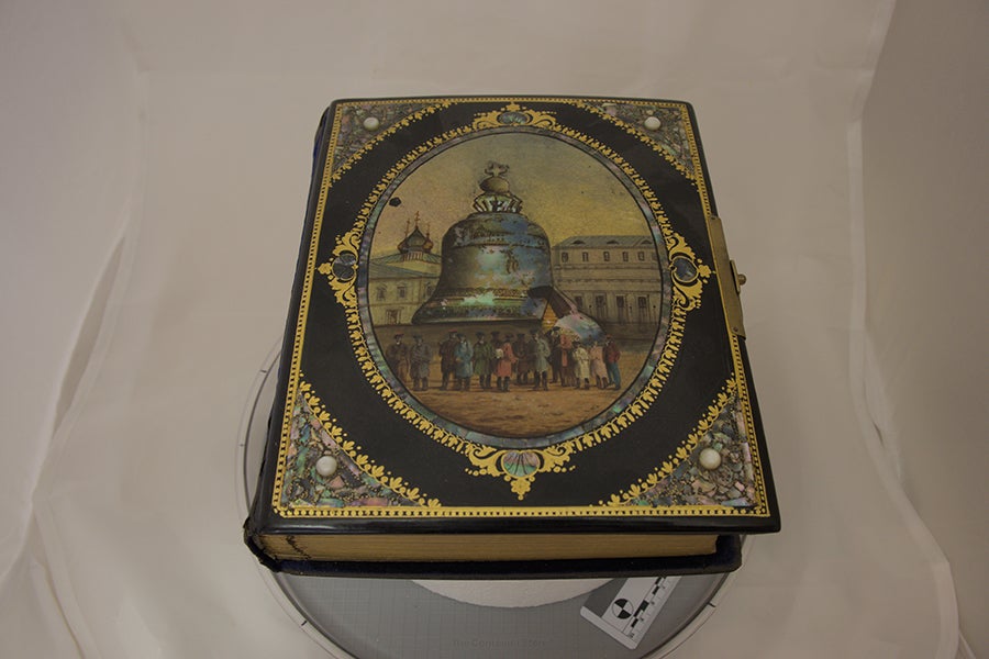 "The Tsar Bell," anonymous artist, mid-late 19th century. Photo album, oil paint on papier-mâché cover with mother of pearl shards, pearls, gilded pages, and a metal lock. Photo by Sophie Works.