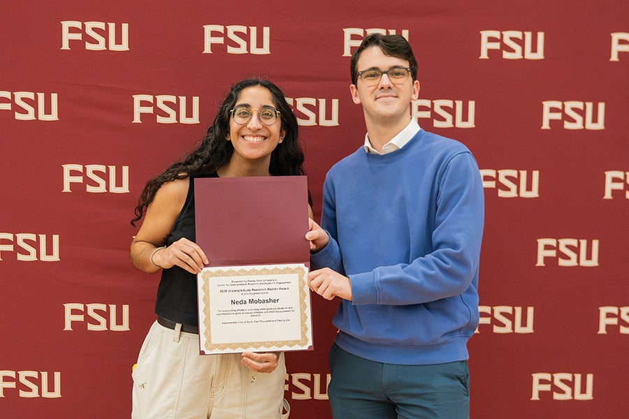 Mobasher receiving a 2026 Graduate Student Undergraduate Research Mentor Award. Photo by Brittany Mobley.