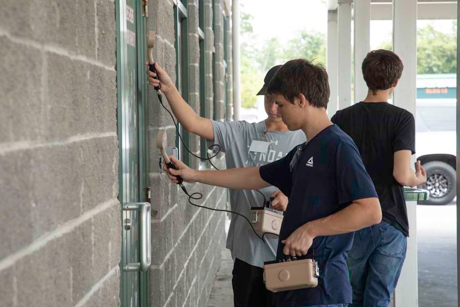 Students hold Geiger counters up to various surfaces during the 2026 Nuclear Medicine and Science Camp at Mosley High School in Lynn Haven, Florida. Photo by Carly Nelson.