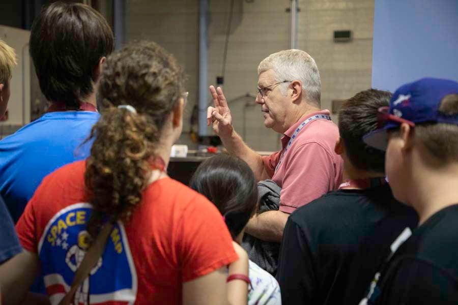 Students listen to a tour guide at the National MagLab in Tallahassee, Florida, as part of the 2026 Nuclear Medicine and Science Camp. Photo by Carly Nelson.
