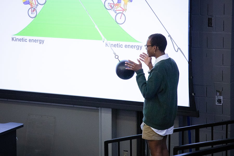 A student participates in a demonstration with a swinging pendulum as part of a Saturday Morning Physics event hosted by the Society of Physics Students at Florida State University on Oct. 11, 2025. Photo by Carly Nelson.