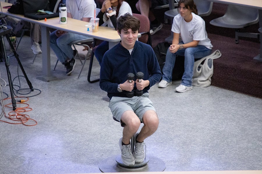 A student sits on a spinning stool during a demonstration as part of a Saturday Morning Physics event hosted by the Society of Physics Students at Florida State University on Oct. 11, 2025. Photo by Carly Nelson.