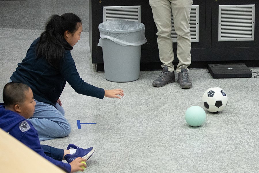 Two students participate in an physics activity rolling balls during a Saturday Morning Physics event at Florida State University on Oct. 18, 2025. Photo by Carly Nelson.