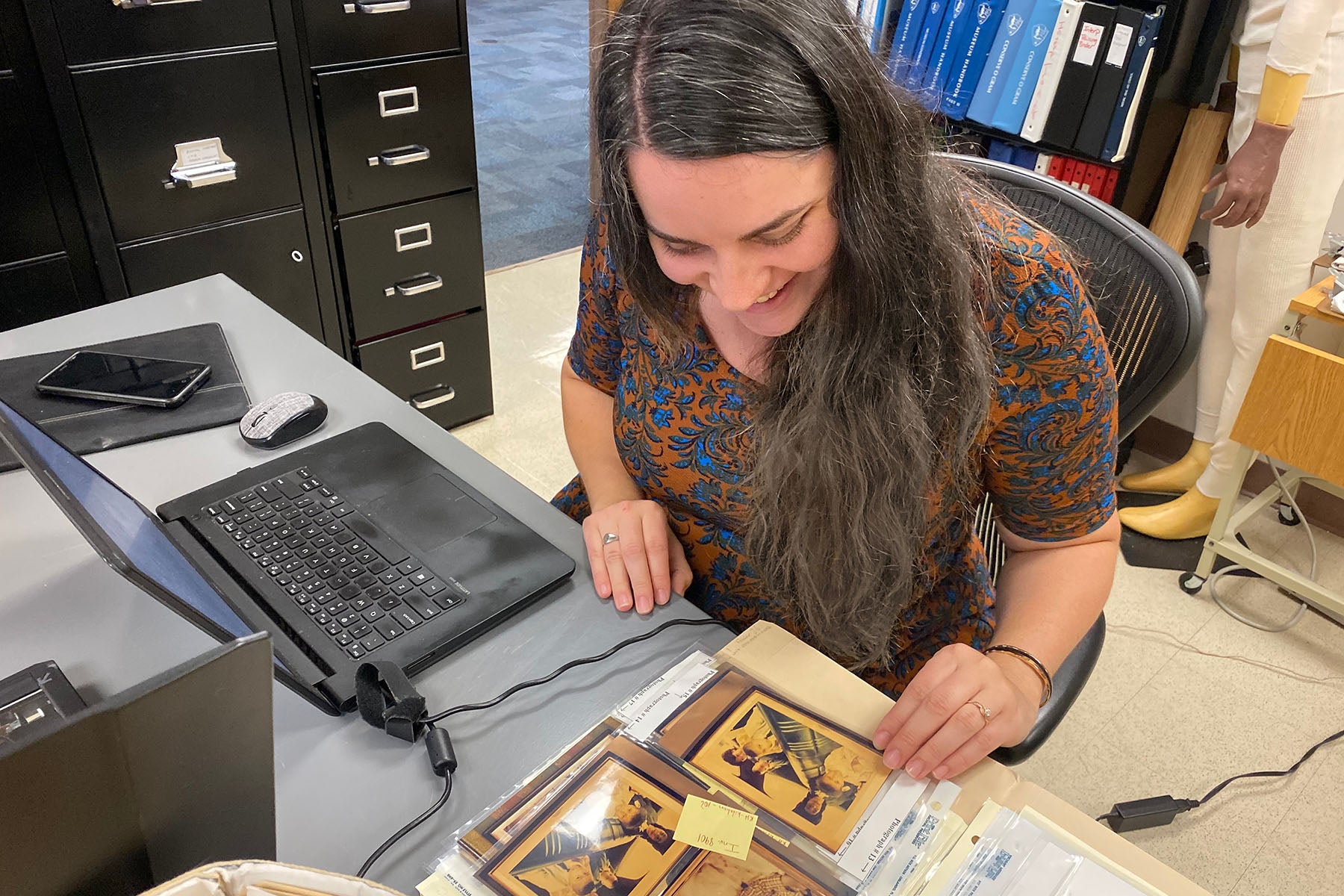 Kathleen Powers Conti examines historic photographs.