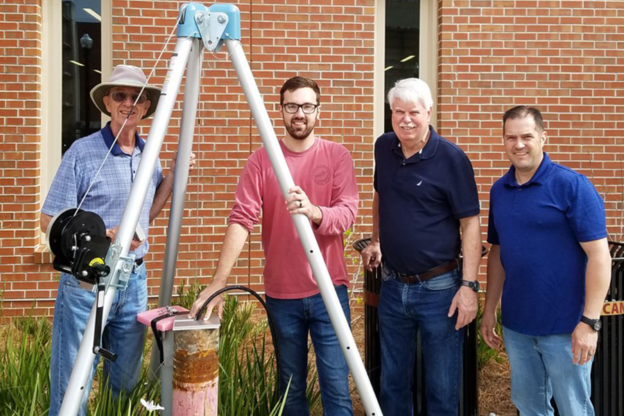 Bob Hutt, geology graduate student James Eke, former EOAS chair James Tull and assistant research specialist Gary White