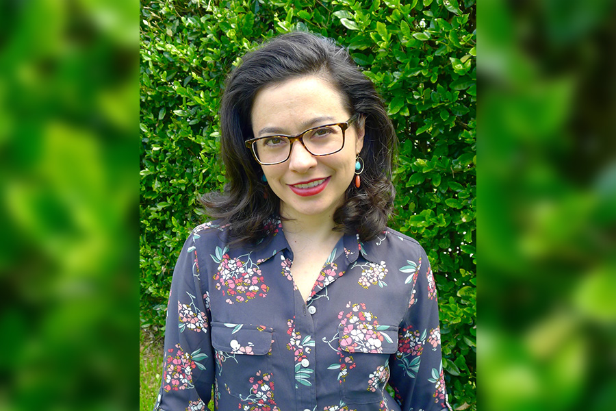 FSU postdoctoral researcher Claire-Marie Hefner in front of green leaves background