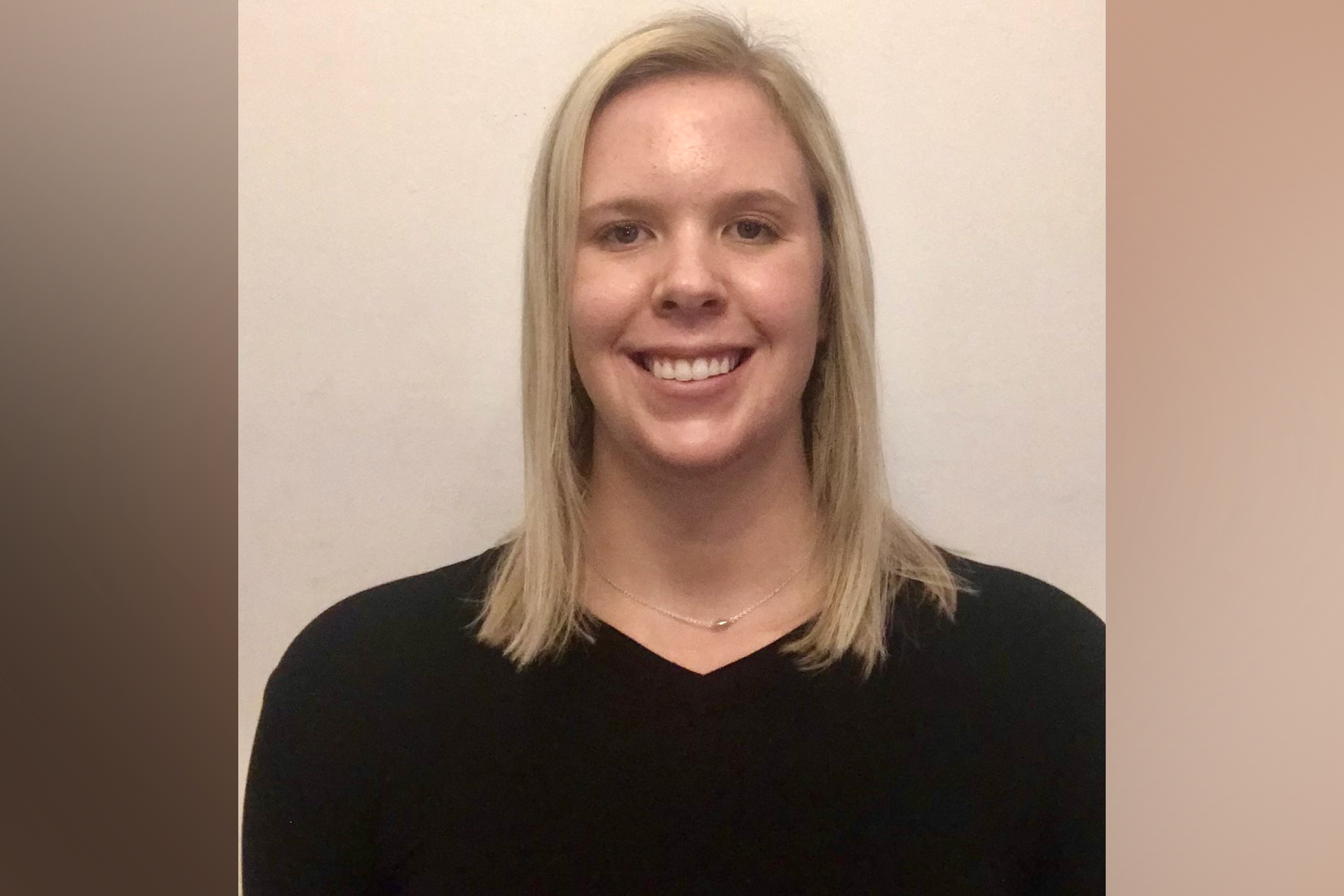 Statistics student Kristine Rosenberger standing in front of a tan background.