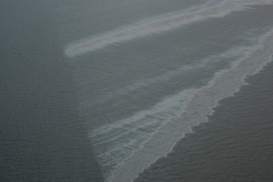 The Taylor Energy platform, about 10 miles off the coast of Louisiana, was destroyed by Hurricane Ivan in 2004 and started leaking oil immediately. Oil slicks, like this picture from 2013, were commonly seen over the site until a containment system was installed in 2019. (Courtesy of Ian MacDonald)